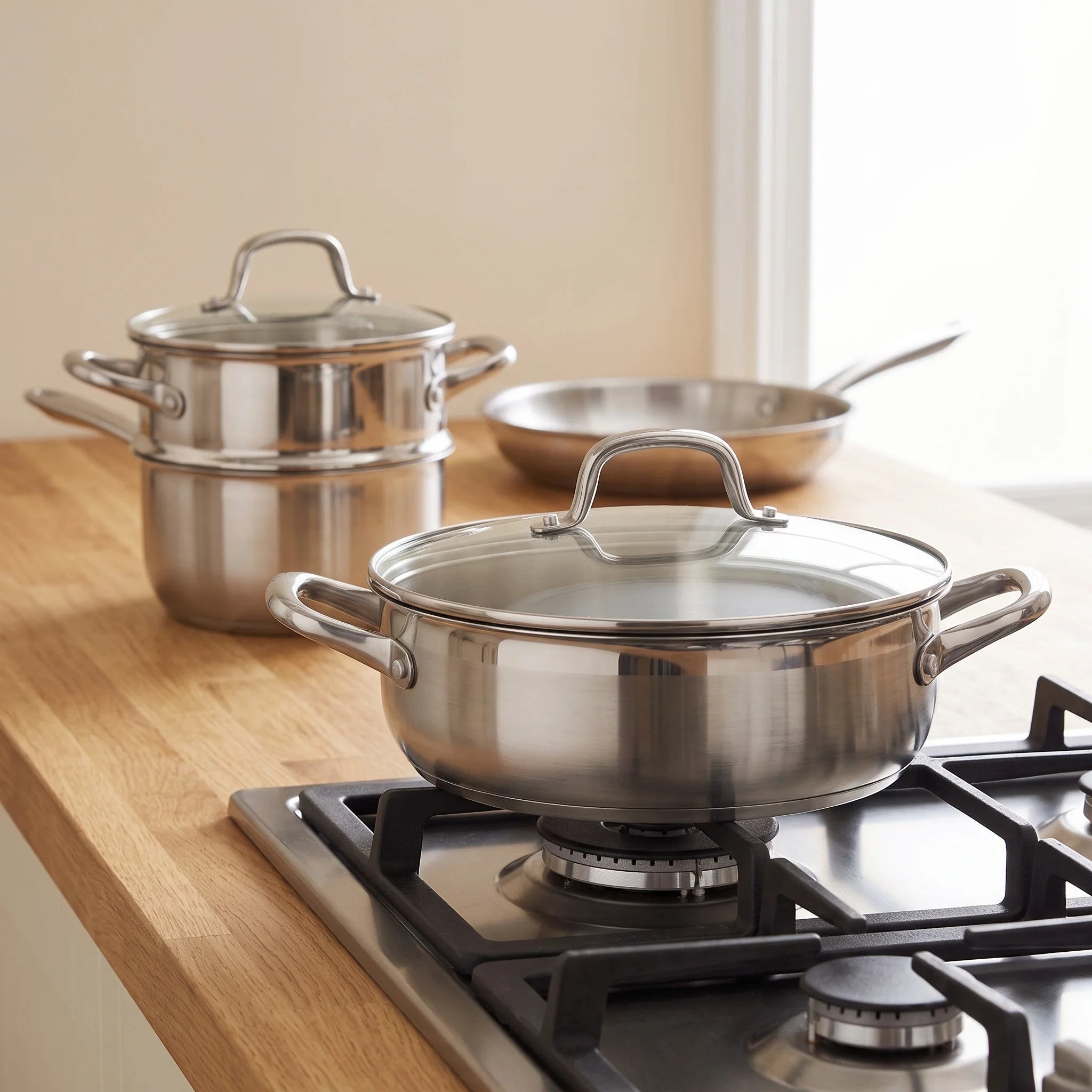 Batterie de cuisine inox 9 pièces, acier trois couches avec couvercles, induction | Marthe