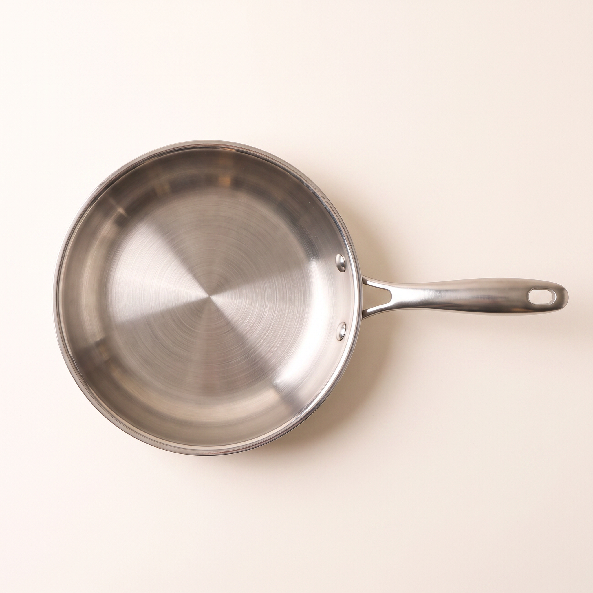 Poêle inox 26 cm vue de dessus, fond entier et trame circulaire
